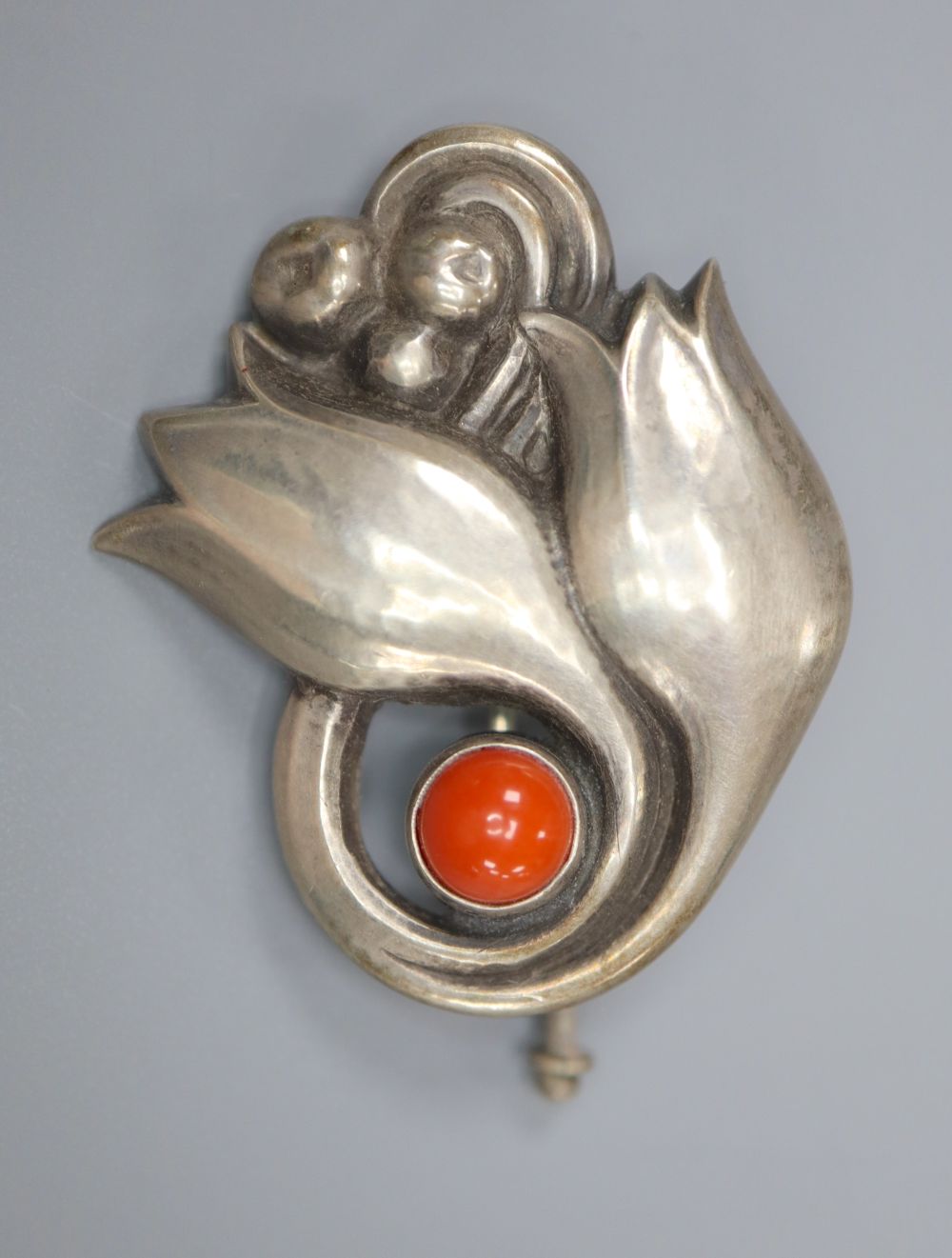 An early 20th century Georg Jensen 830 white metal and coral bead set tulip and berry brooch, no. 100, 31mm.