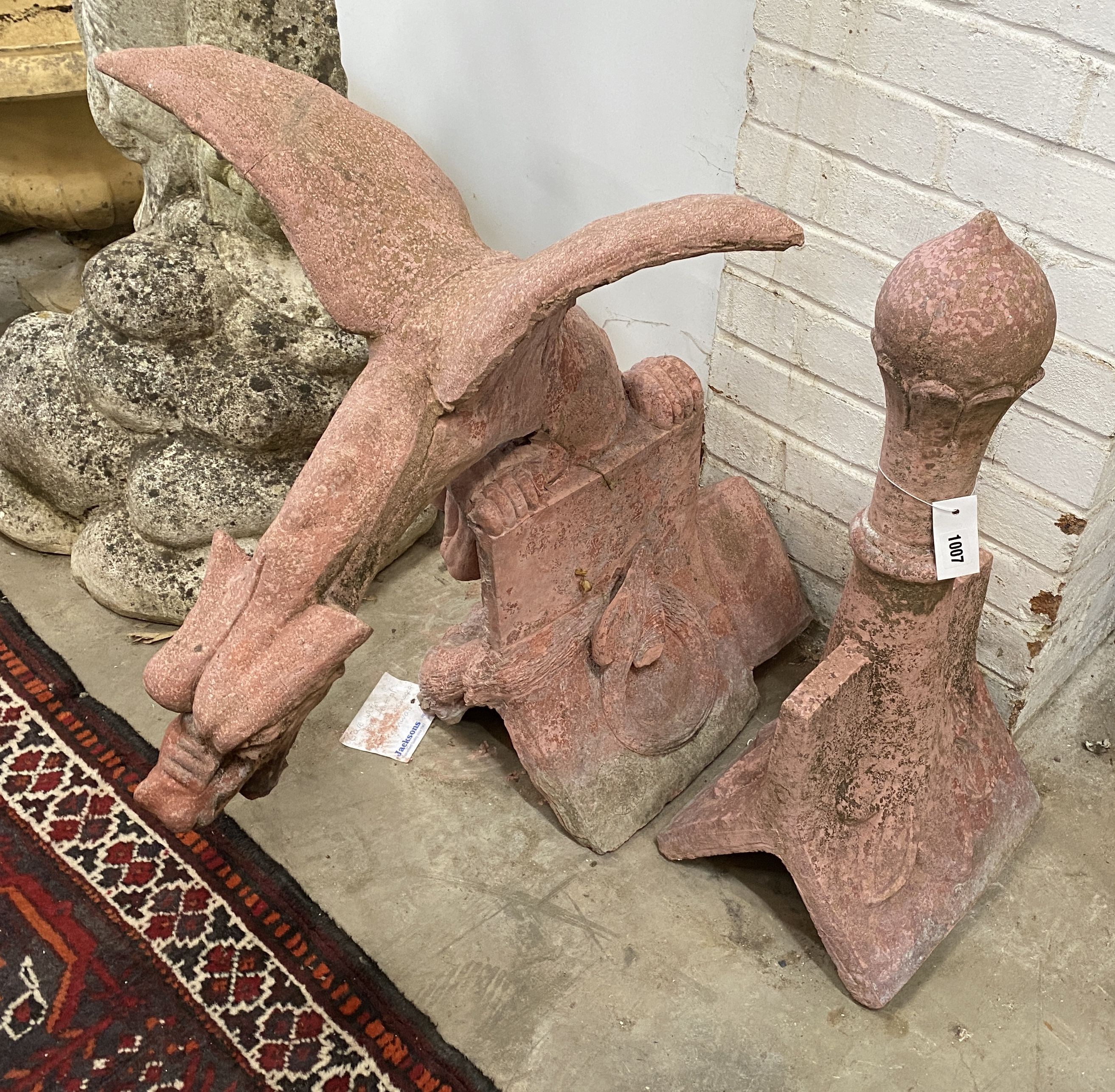 A painted reconstituted stone gargoyle hip tile together with a ball finial hip tile, largest height 69cm