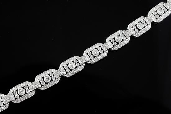An Art Deco style 18ct white gold and diamond set octagonal link bracelet, 18.5cm. An Art Deco style 18ct white gold and diamond set octagonal link bracelet, 18.5cm.