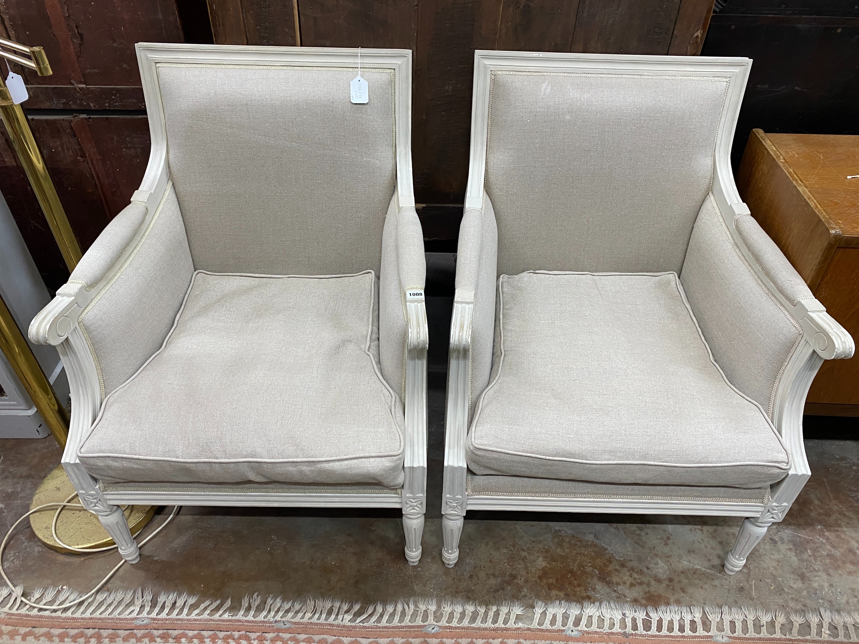 A pair of French style white painted upholstered armchairs, width 68cm, depth 70cm, height 91cm