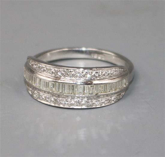 A modern 18ct white gold and three row channel set diamond ring, size X. A modern 18ct white gold and three row channel set diamond ring, size X.
