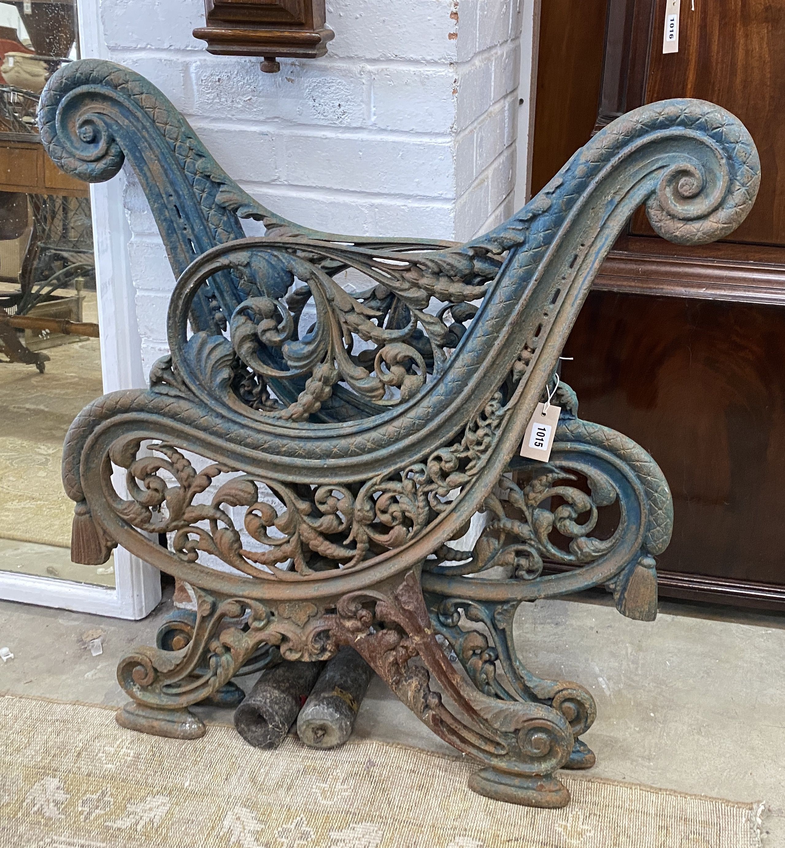 A pair of Victorian Coalbrookdale style painted cast iron bench ends, height 85cm