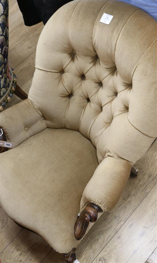 A Victorian mahogany-framed low armchair with scrolled terminals, deep-buttoned beige upholstery A Victorian mahogany-framed low armchair with scrolled terminals, deep-buttoned beige upholstery