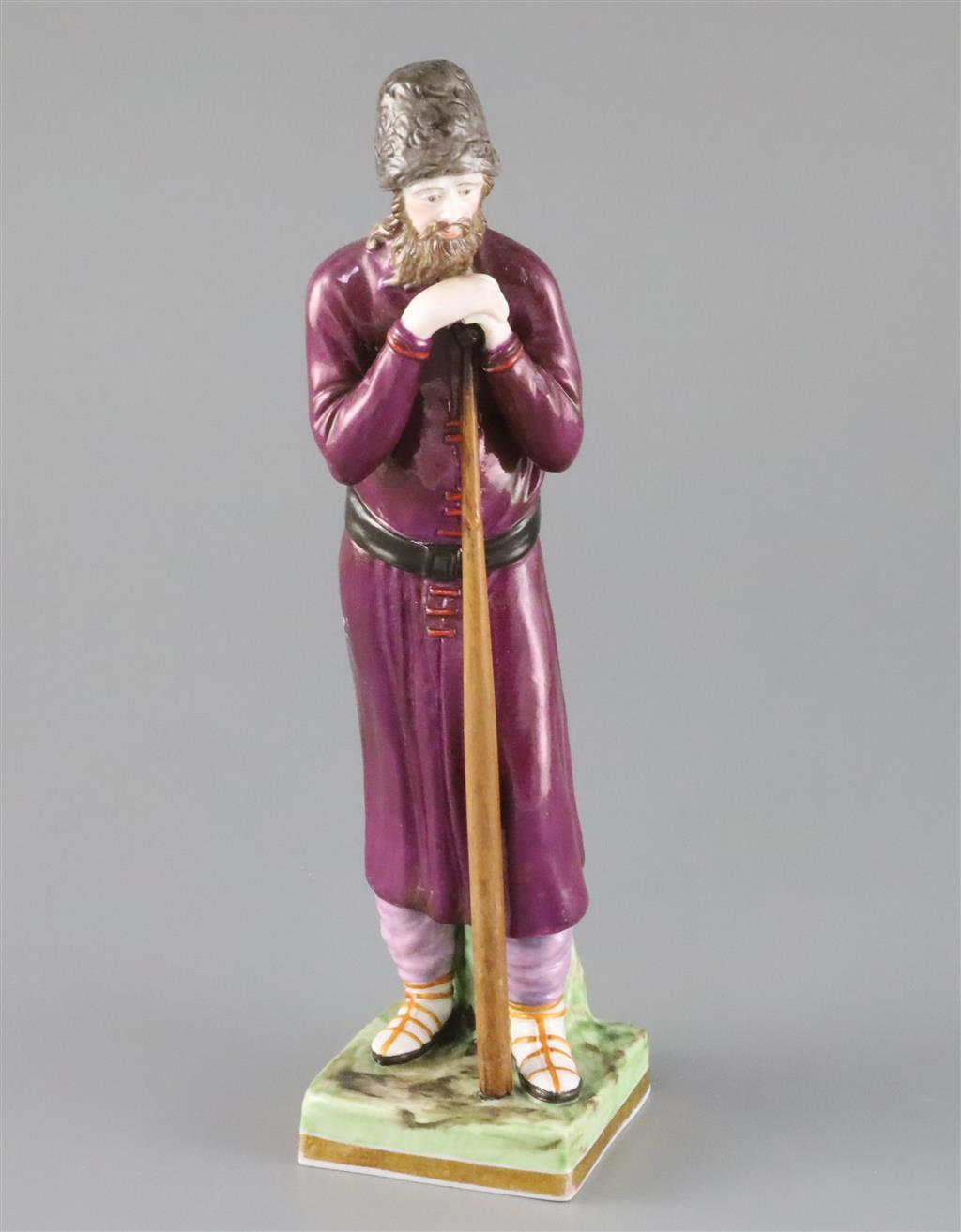 A Russian Gardner porcelain figure of a man holding a staff, mid 19th century, H.21.4cm, loss to left hand and replacement staff A Russian Gardner porcelain figure of a man holding a staff, mid 19th century, H.21.4cm, loss to left hand and replacement staff