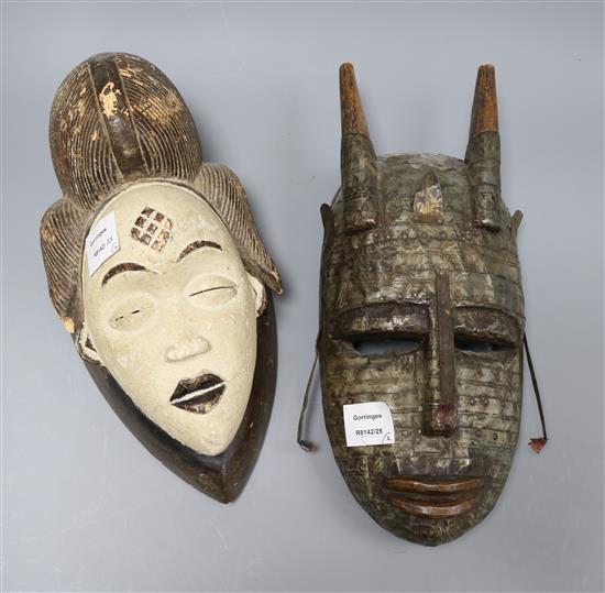 A Gabon stained wood mask and a metal overlaid zoomorphic mask longest 39cm