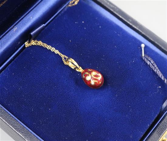 A cased Victor Mayer for Faberge 18ct gold, red enamel and diamond set egg pendant, on 18ct gold chain, numbered 142/500, A cased Victor Mayer for Faberge 18ct gold, red enamel and diamond set egg pendant, on 18ct gold chain, numbered 142/500,