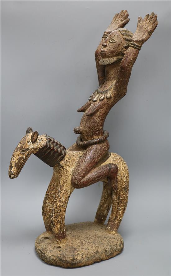 A Yoruba patinated wood group of a woman riding a horse height 65cm