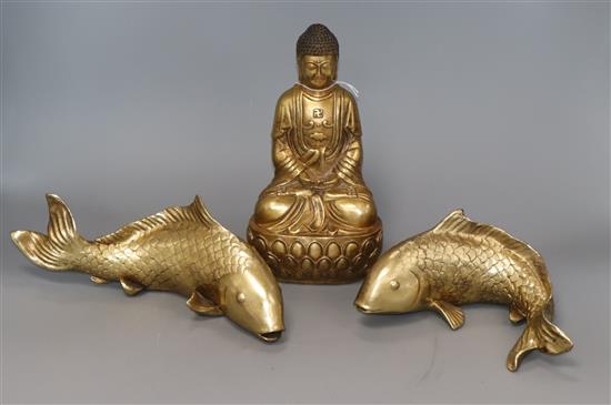 An Eastern gilt metal Buddha and a pair of resin carp Buddha 24cm An Eastern gilt metal Buddha and a pair of resin carp Buddha 24cm
