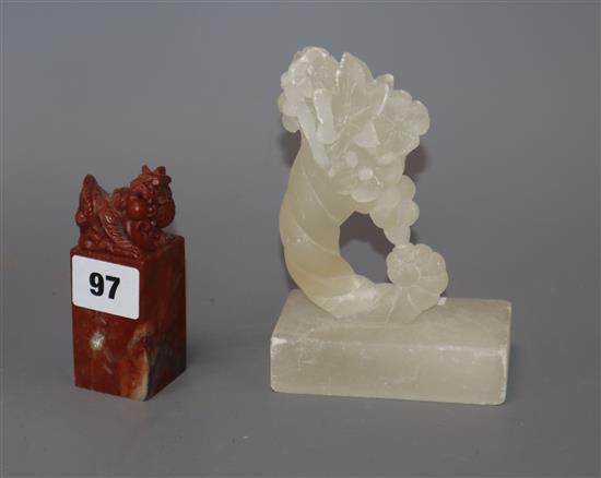 A carved alabaster cornucopia ornament, a carved red soapstone chop height 14cm A carved alabaster cornucopia ornament, a carved red soapstone chop height 14cm