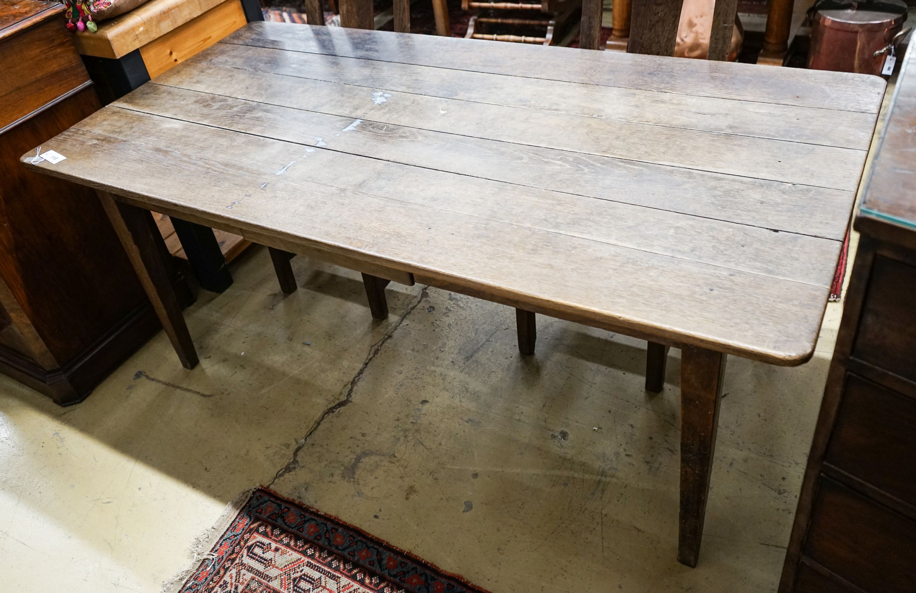 An early 19th century French provincial oak farmhouse table, fitted drawer, length 175cm, depth 86cm, height 73cm
