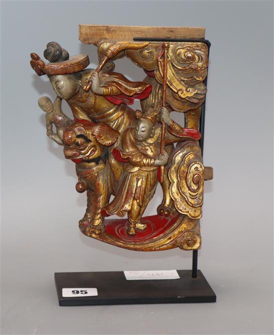 A Chinese gilt and red lacquered carving of figures, on stand length 20cm excl. stand A Chinese gilt and red lacquered carving of figures, on stand length 20cm excl. stand