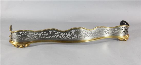 A Victorian gilt brass and steel serpentine fender, W.4ft 8in. A Victorian gilt brass and steel serpentine fender, W.4ft 8in.