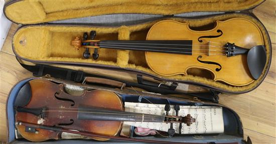 A cased violin and a three quarter size violin A cased violin and a three quarter size violin