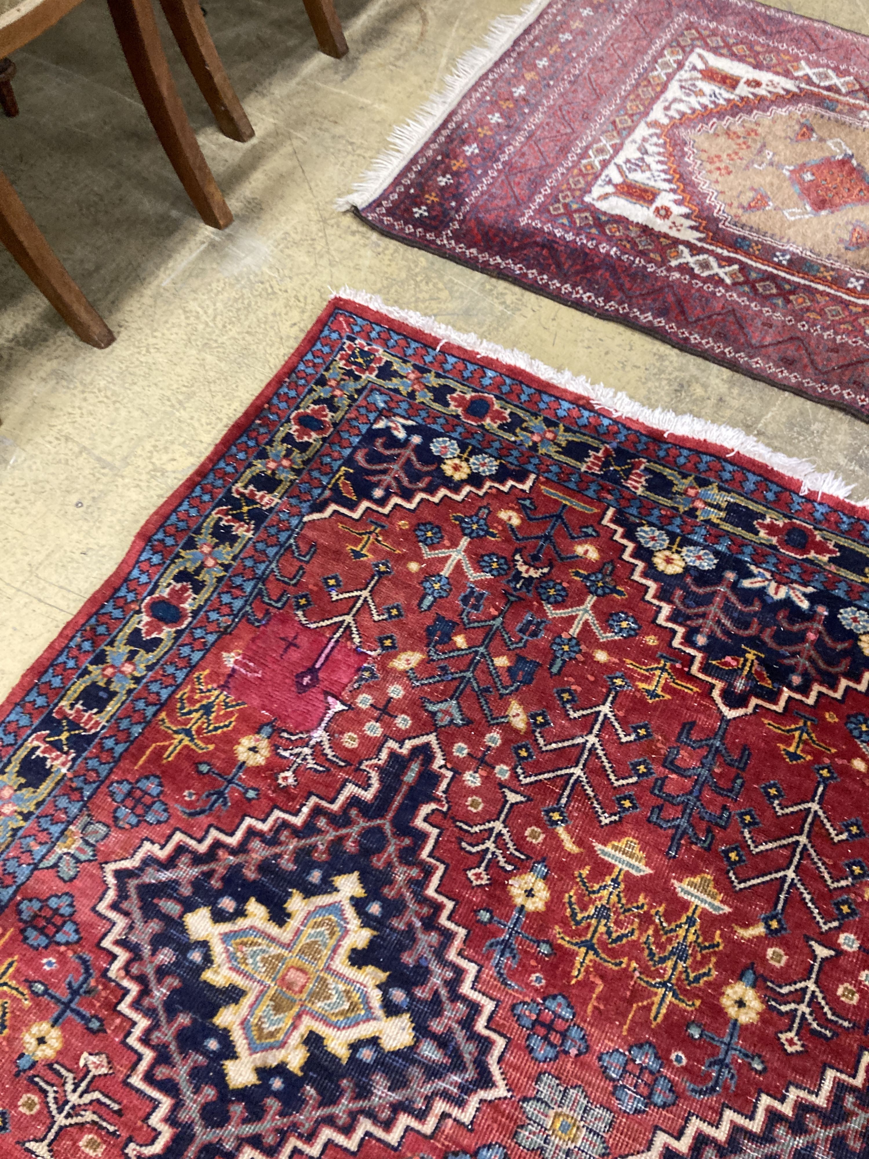 A Caucasian design red ground rug, 206 x 134cm together with a smaller West Persian design rug