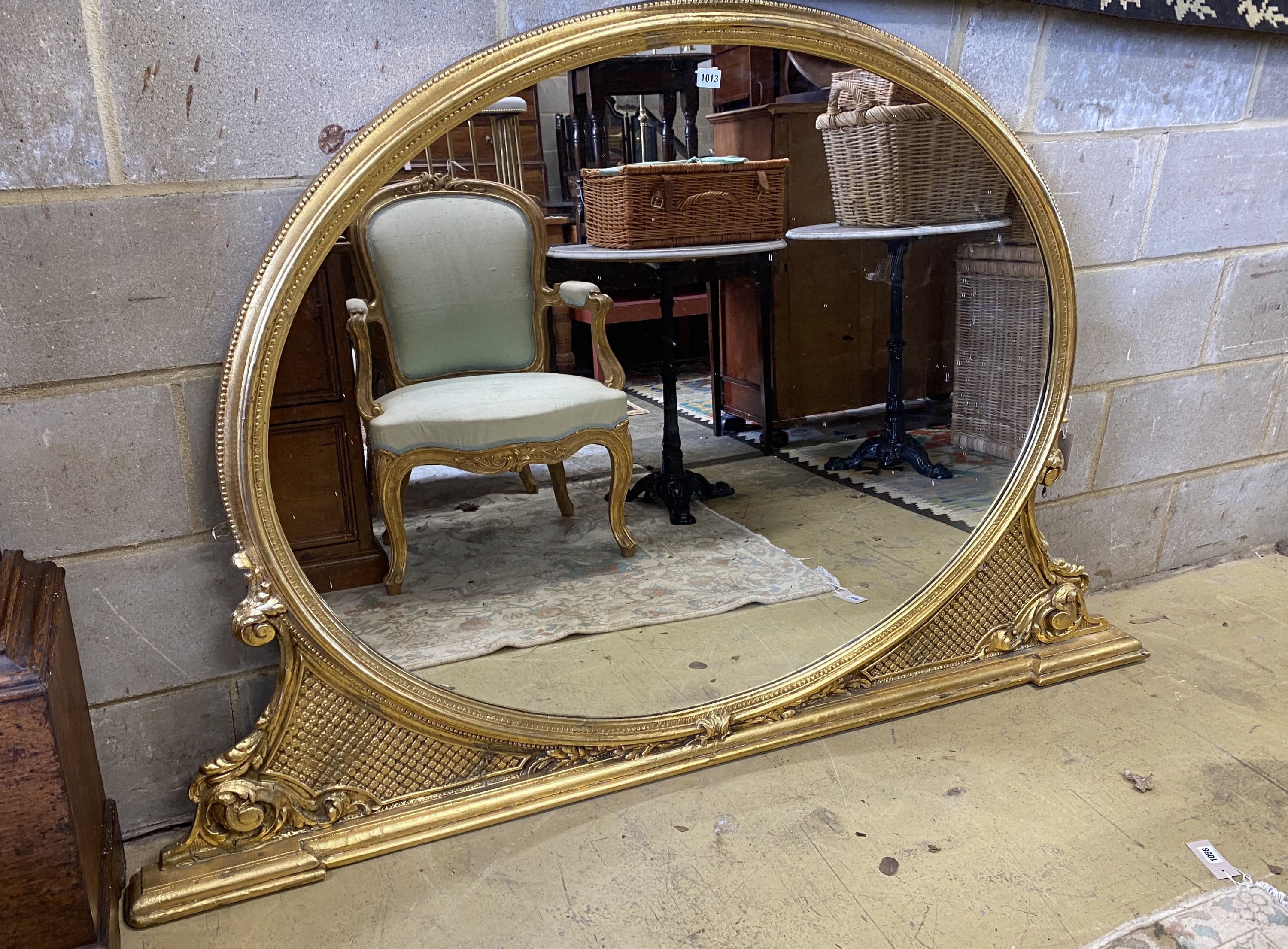 A Victorian style gilt framed overmantel mirror with oval plate, width 172cm, height 114cm
