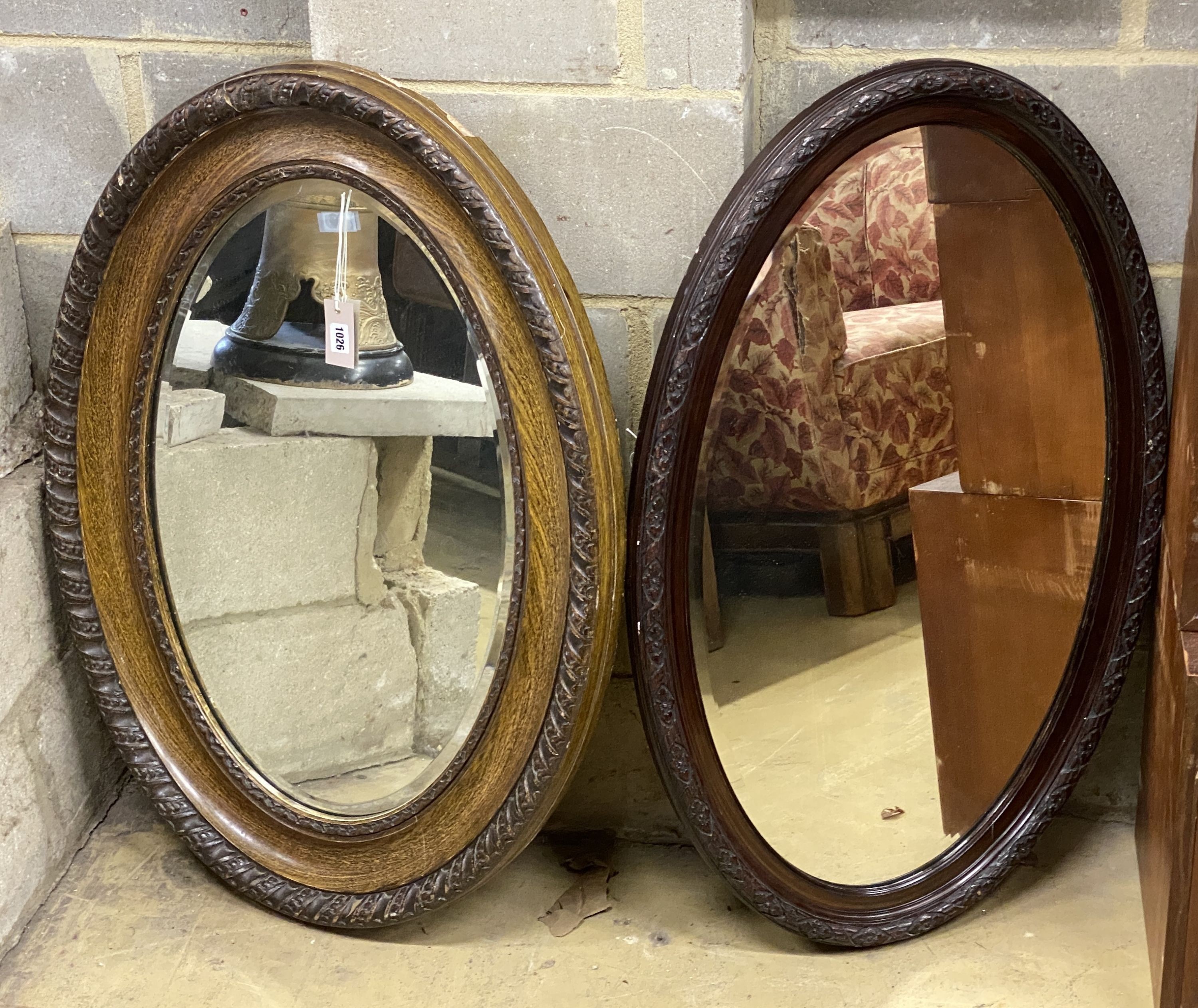 Two early 20th century oval simulated grain wall mirrors, larger width 68cm, height 96cm