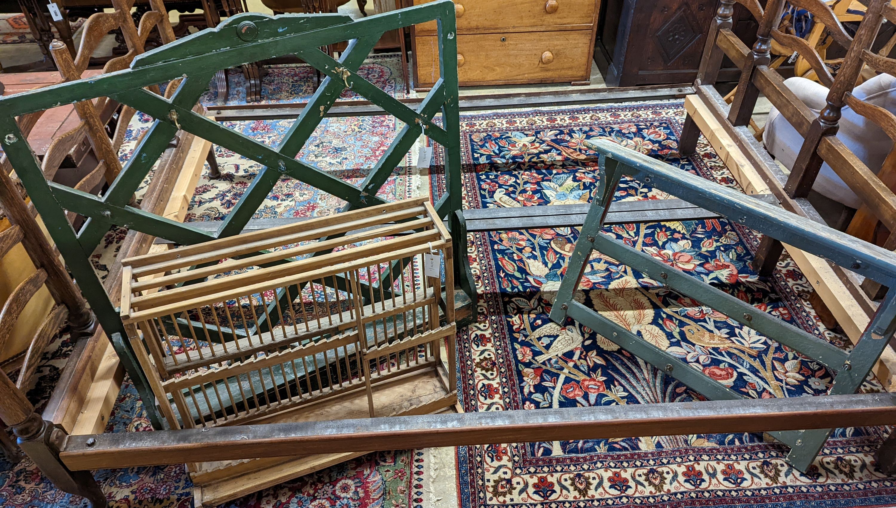 Two 19th century painted wall racks, together with a plate rack, largest width 100cm, height 104cm