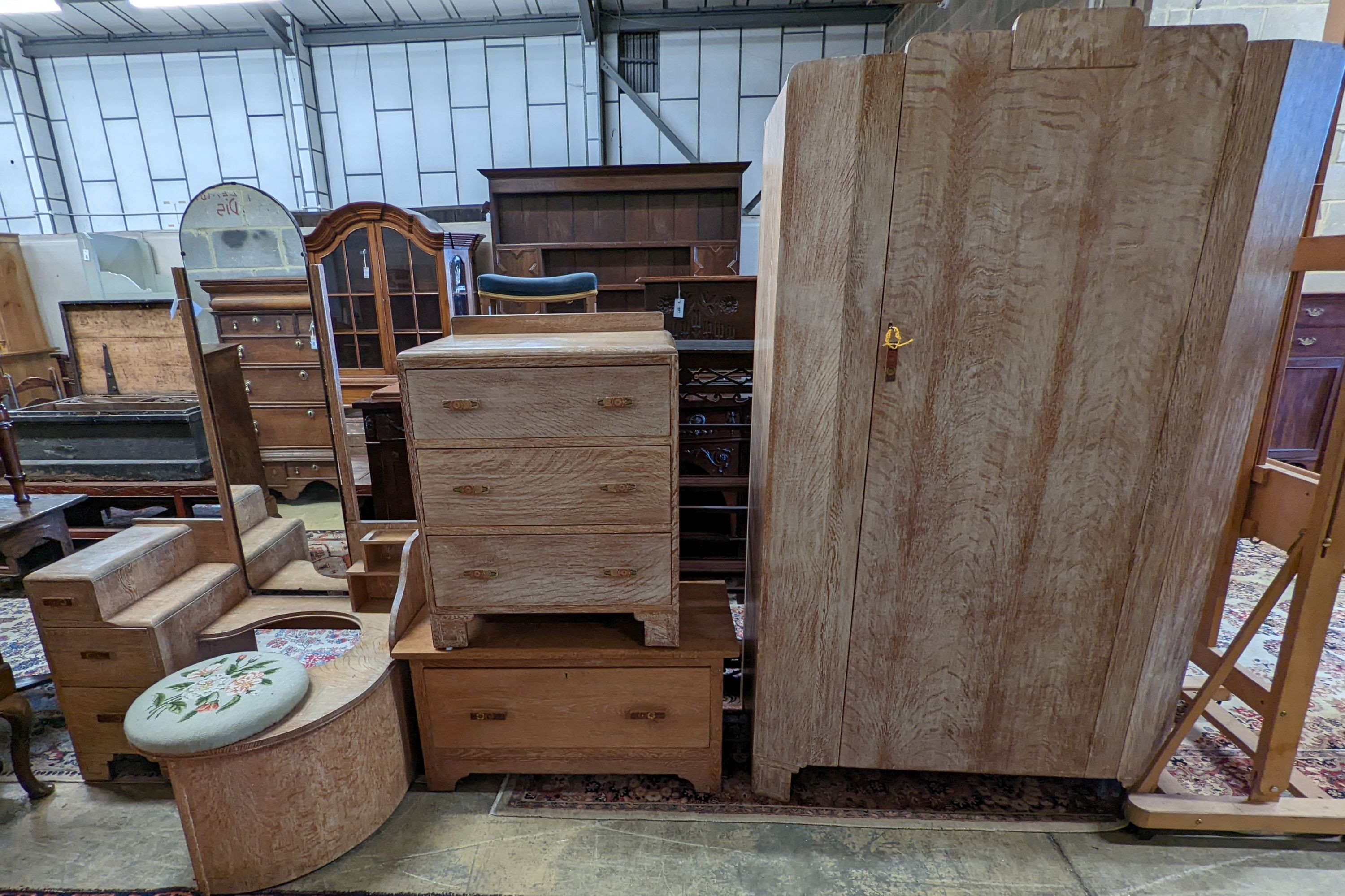 An Art Deco style limed oak three piece bedroom suite and a similar low chest, wardrobe width 108cm depth 51cm height 185cm