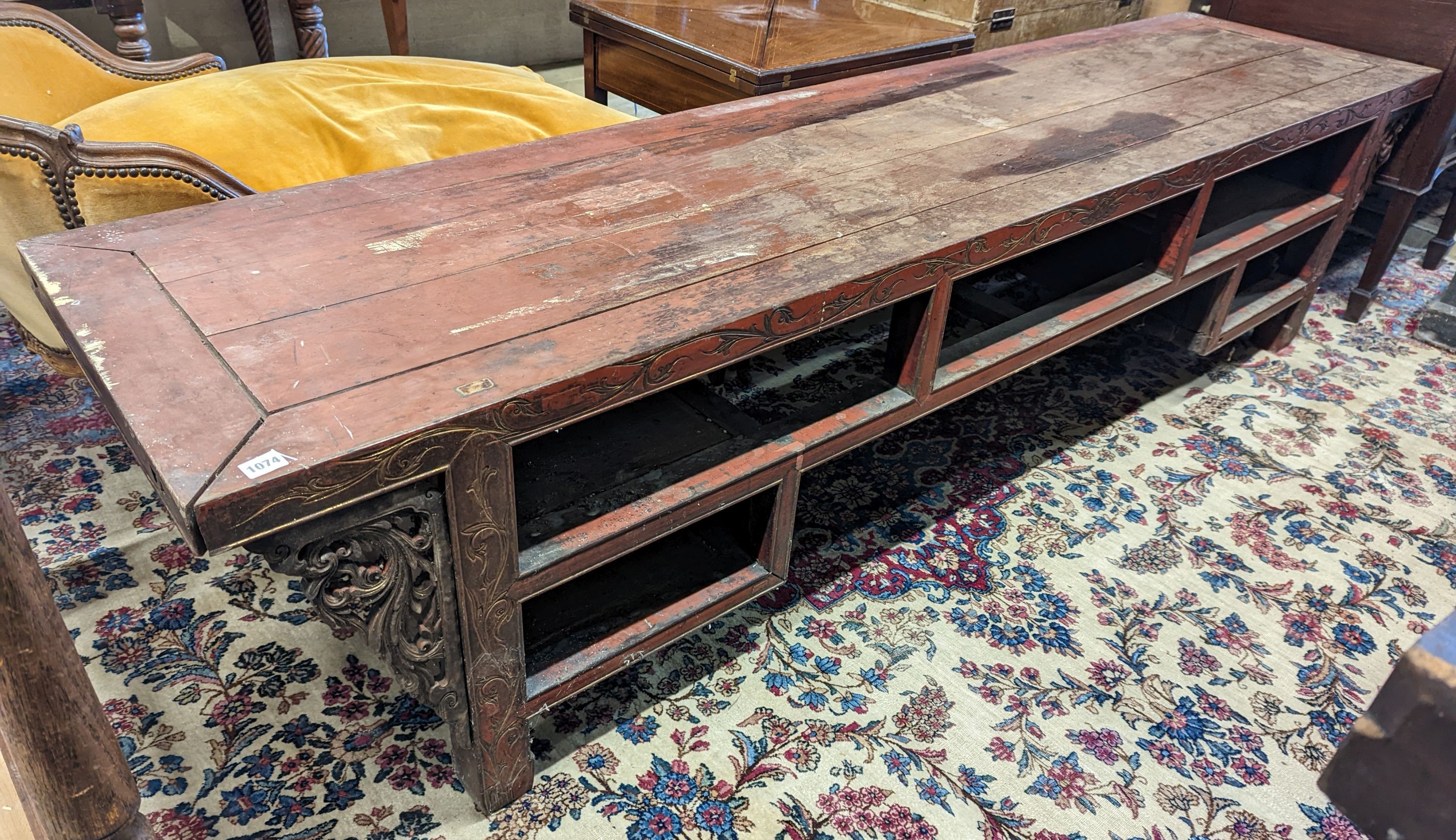 A Chinese red lacquer hardwood low altar table, width 240cm depth 56cm height 56cm