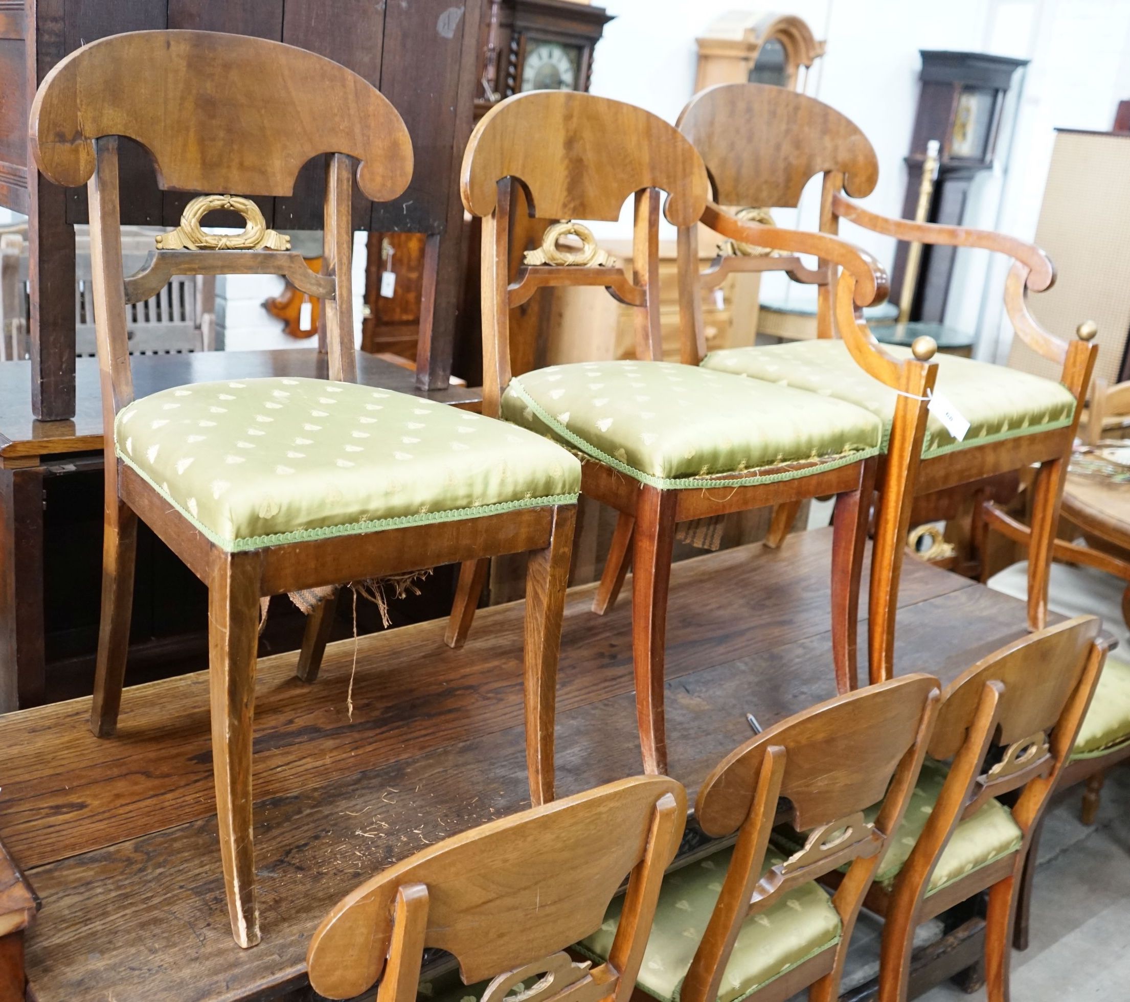 A set of eight Swedish Biedermeier birch with mahogany veneer, wreath design dining room chairs, including two carvers, mid 19th century