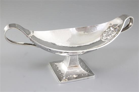 A George V Arts & Crafts silver navette shaped two handled dish, by Albert Edward Jones, Width 12 ¾”/320mm Weight: 18.3oz/520grms A George V Arts & Crafts silver navette shaped two handled dish, by Albert Edward Jones, Width 12 ¾”/320mm Weight: 18.3oz/520grms