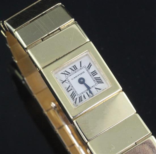 A ladys 18ct gold Cartier quartz bracelet watch, with Cartier pouch. A ladys 18ct gold Cartier quartz bracelet watch, with Cartier pouch.