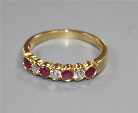 An 18ct yellow gold, ruby and diamond seven-stone ring, collet-set size P/Q. An 18ct yellow gold, ruby and diamond seven-stone ring, collet-set size P/Q.