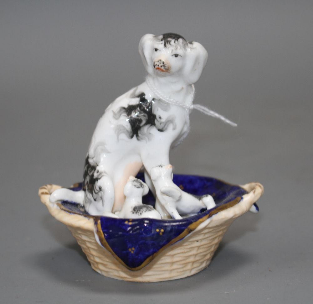 A Staffordshire group of a King Charles Spaniel and two puppies in a basket, c.1830-50, possibly Dudson,