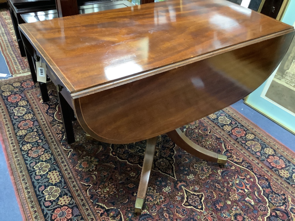 A late Georgian inlaid mahogany pedestal Pembroke table,on quadripartite splayed supports with brass castors, width 92cm depth 52cm height 70cm