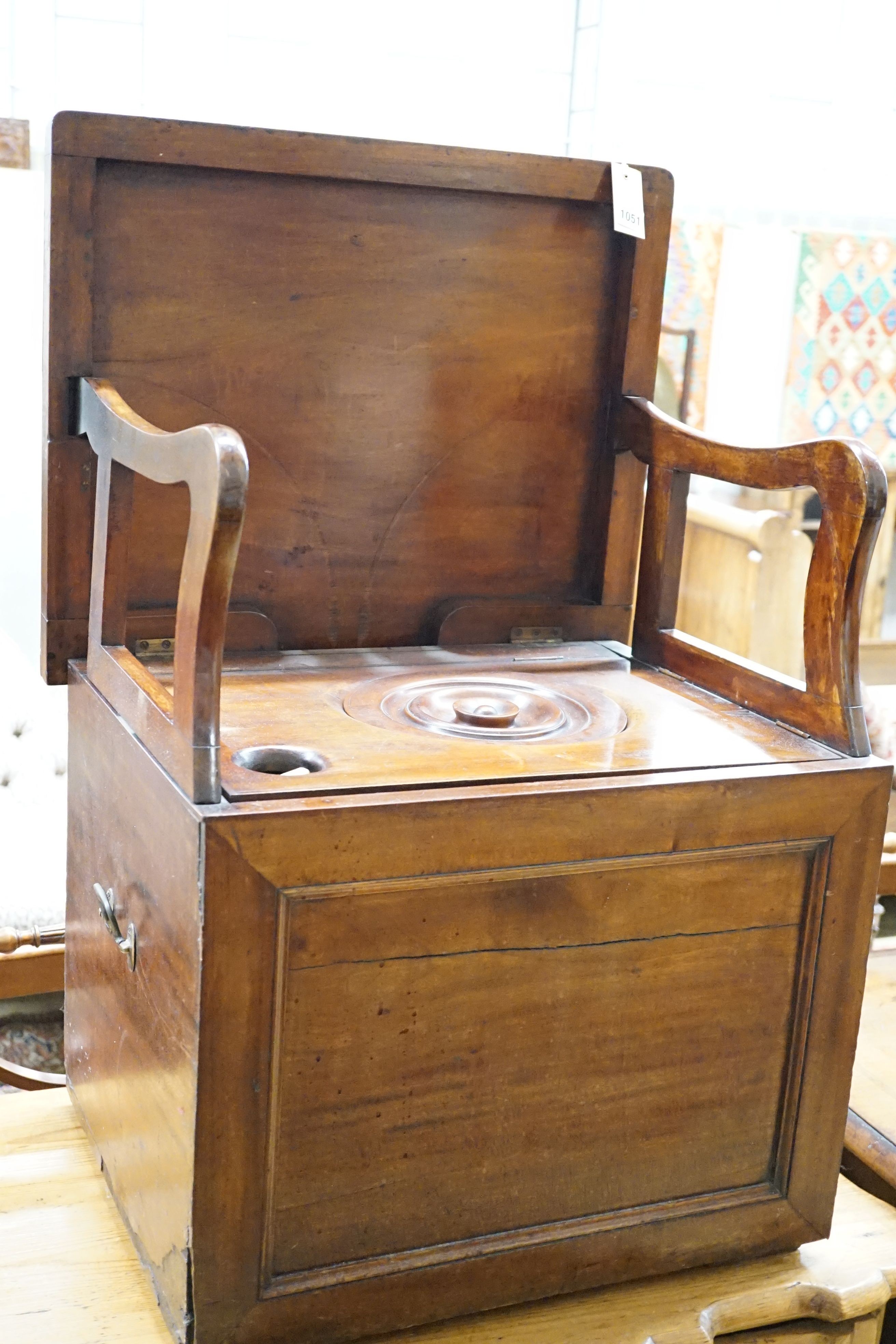 An early 19th century mahogany box commode with folding top and bone handled brass pump handle, width 57cm