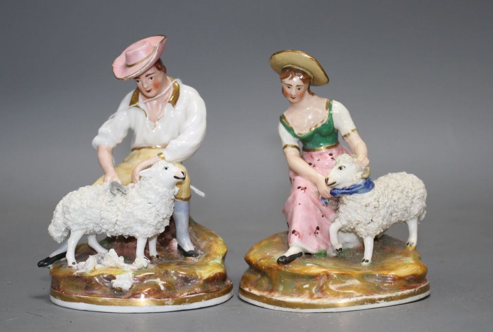 A pair of Staffordshire porcelain groups of a shepherd and shepherdess, c.1830-50, H. 11.5 -12.5cm