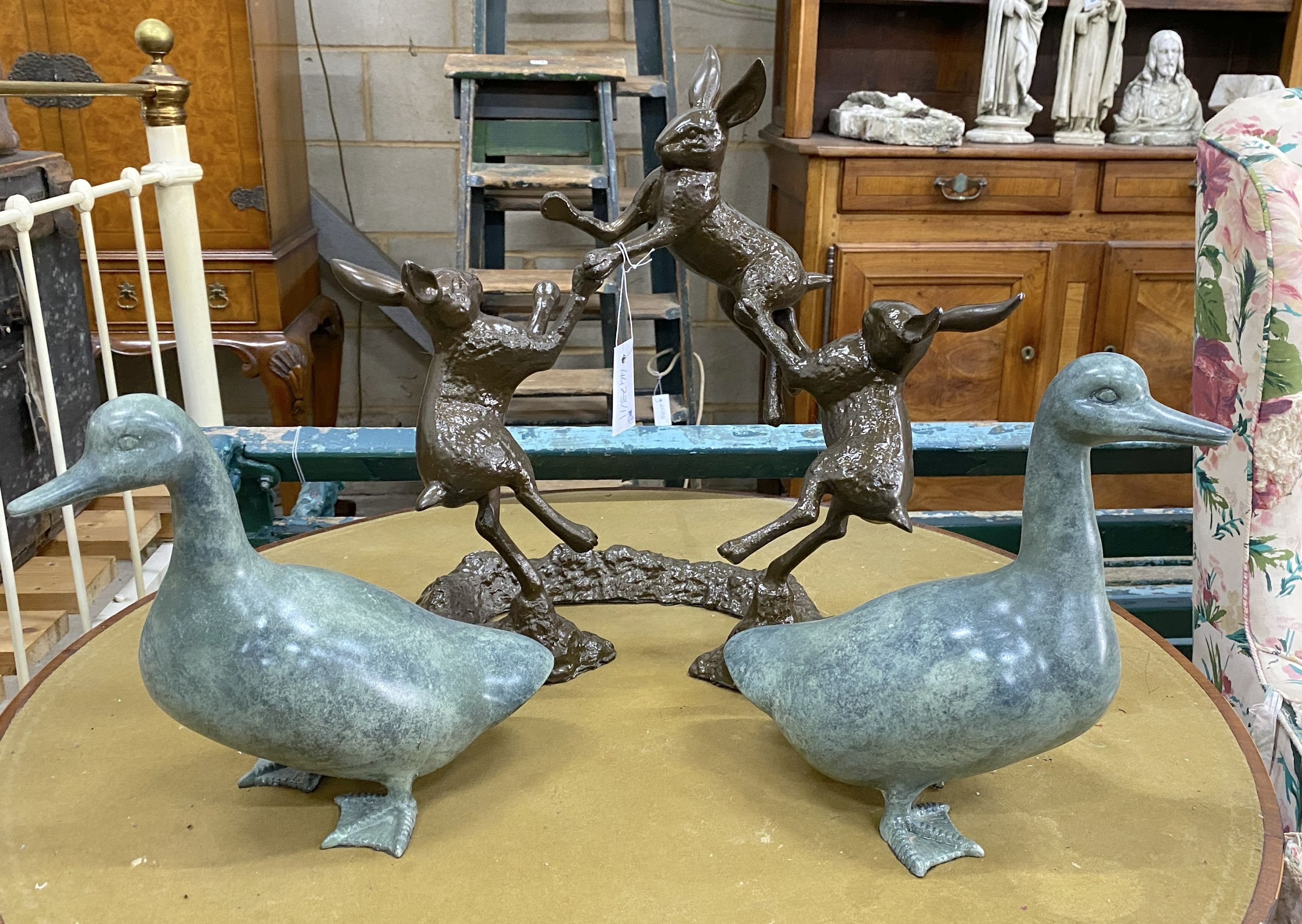 A simulated bronze hare garden ornament, height 46cm, together with two faux bronze models of ducks