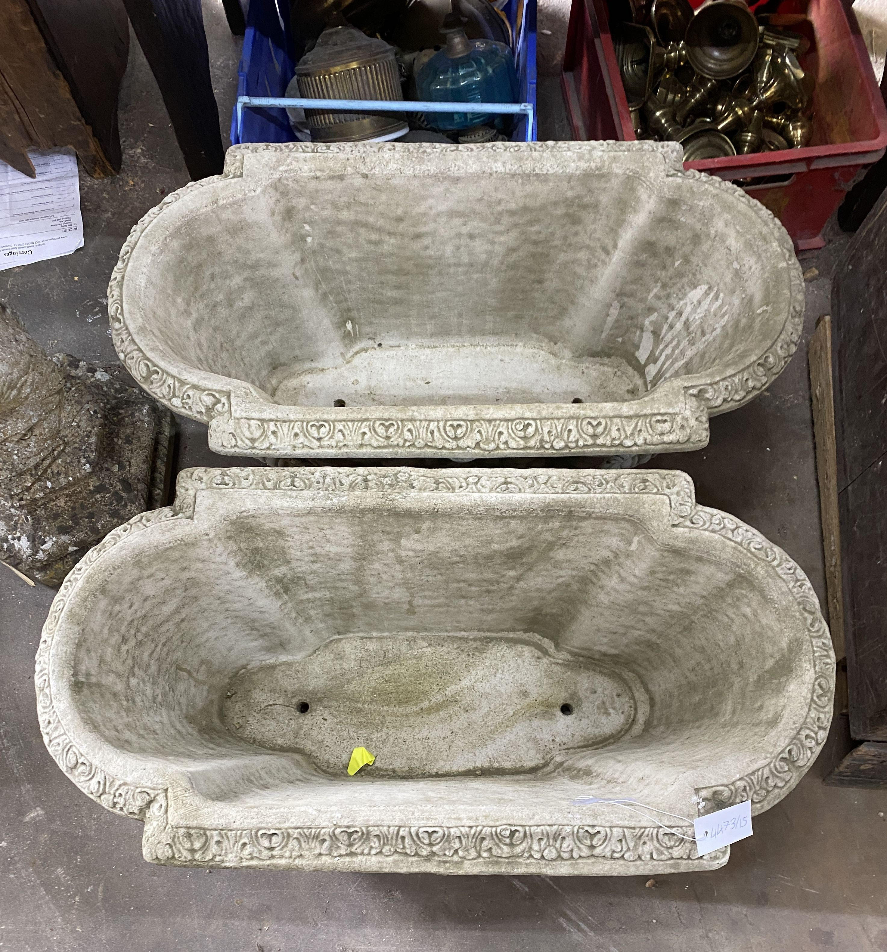 A pair of shaped oval reconstituted stone garden planters with floral swag bodies, width 82cm, depth 42cm, height 34cm