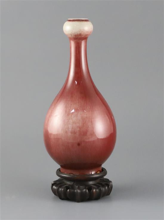 A Chinese sang de boeuf lang yao garlic neck vase, 19th century, H.24cm, two small foot chips, wood stand A Chinese sang de boeuf lang yao garlic neck vase, 19th century, H.24cm, two small foot chips, wood stand