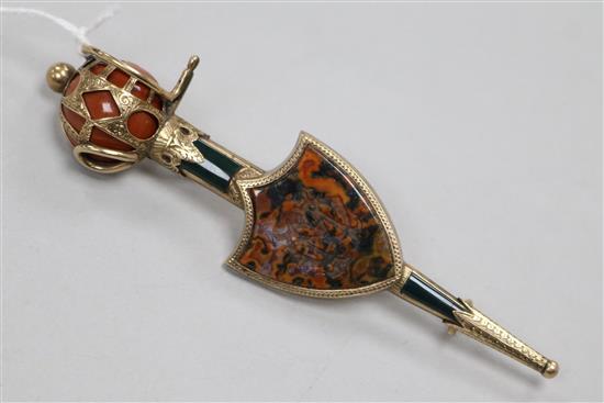 A Victorian Scottish gold and hardstone set sword and shield brooch, 10.1cm. A Victorian Scottish gold and hardstone set sword and shield brooch, 10.1cm.