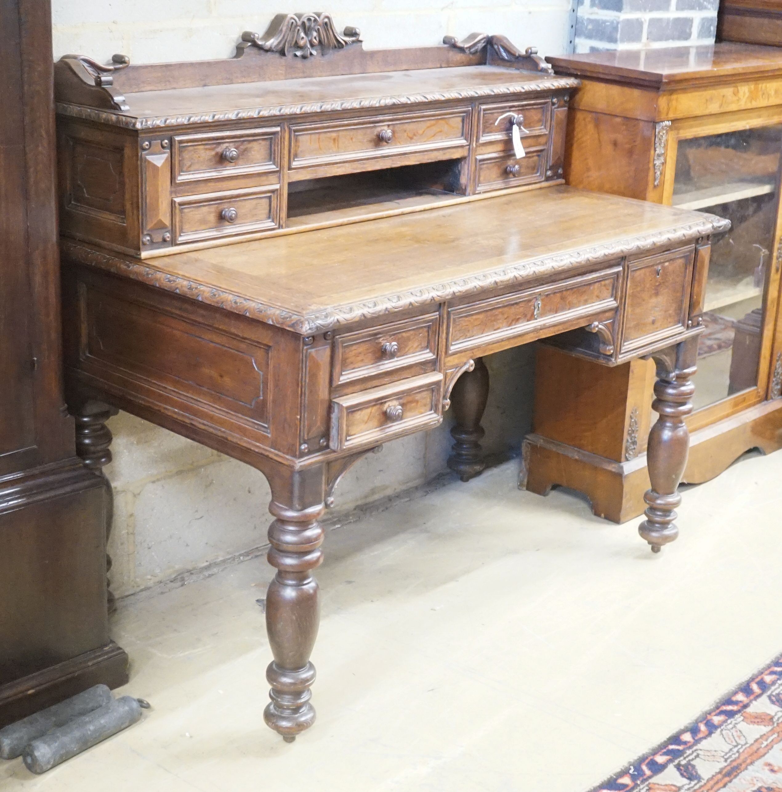 A Victorian carved oak kneehole desk, width 124cm depth 69cm height 110cm