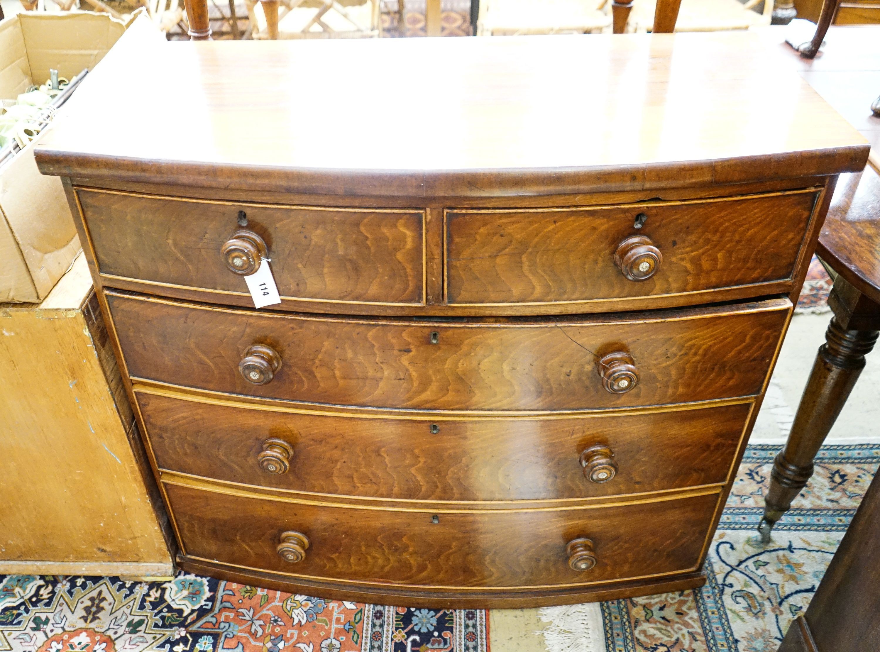 A Victorian mahogany bow fronted chest of drawers (lacking feet), width 105cm, depth 50cm, height 92cm