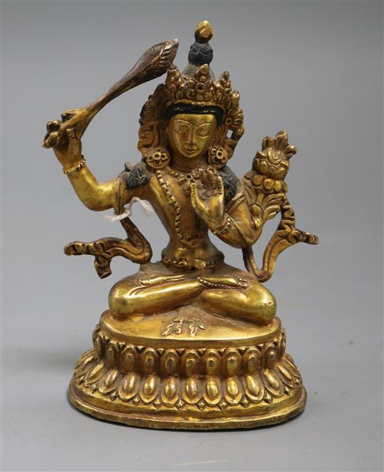 A Sino-Tibetan gilt bronze figure of a deity A Sino-Tibetan gilt bronze figure of a deity