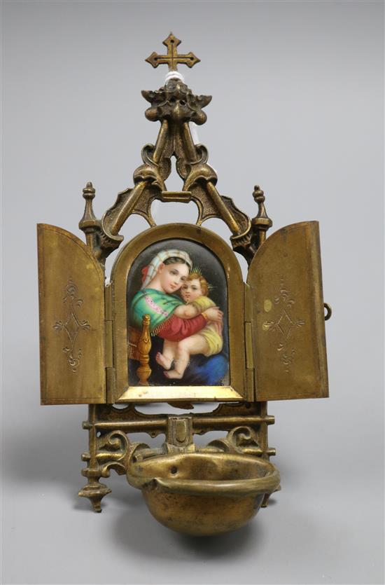 A Continental brass and ceramic religious plaque of a mother and child A Continental brass and ceramic religious plaque of a mother and child