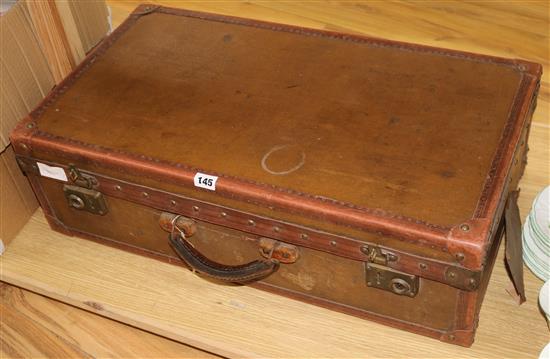 A brown canvas suitcase