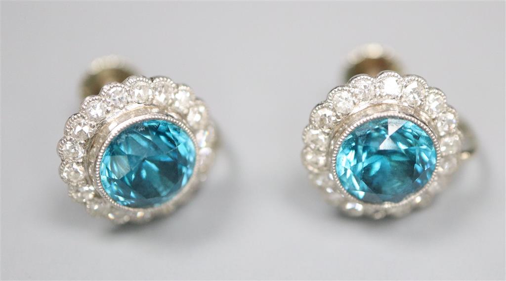 A pair of modern white metal, blue zircon and diamond cluster set circular ear clips, 11mm, gross 4.5 grams.
