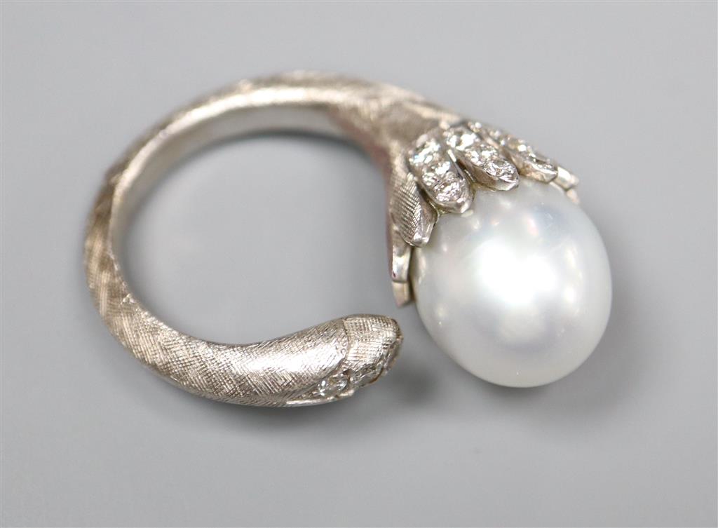 A modern textured white metal (possibly platinum), cultured pearl and diamond set openwork dress ring,