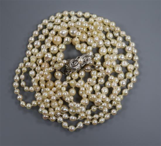 A long single strand graduated cultured pearl necklace, with 14ct white gold Mikimoto clasp, 162cm. A long single strand graduated cultured pearl necklace, with 14ct white gold Mikimoto clasp, 162cm.