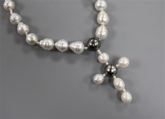 A baroque pearl cross pendant necklace, with white and yellow metal clasp, pendant 7.4mm. A baroque pearl cross pendant necklace, with white and yellow metal clasp, pendant 7.4mm.