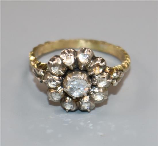 A 19th century yellow metal and rose cut diamond set cluster ring, with carved shank, size L. A 19th century yellow metal and rose cut diamond set cluster ring, with carved shank, size L.
