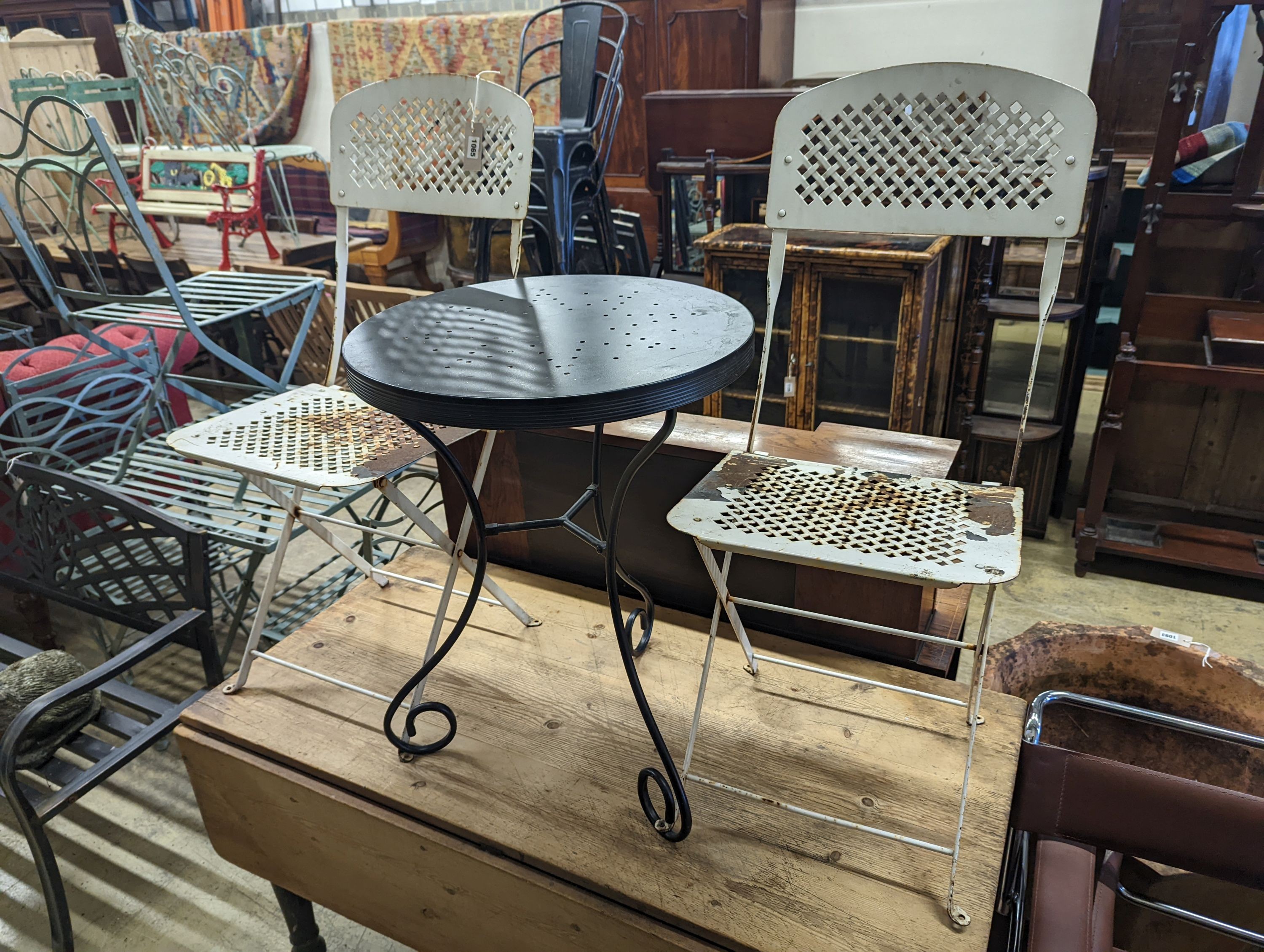 A circular metal bistro table, diameter 49cm, height 65cm and two chairs