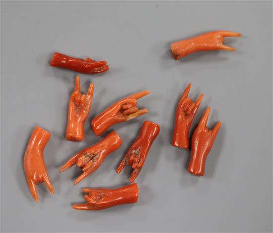 Ten miniature carved coral hands. Ten miniature carved coral hands.