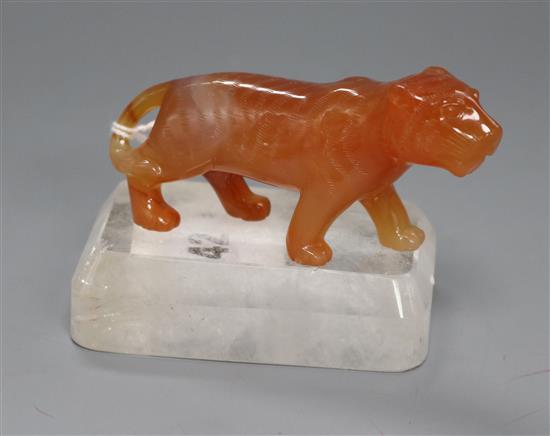 A Chinese chalcedony figure of a tiger with a rock crystal, on stand width 9.5cm A Chinese chalcedony figure of a tiger with a rock crystal, on stand width 9.5cm