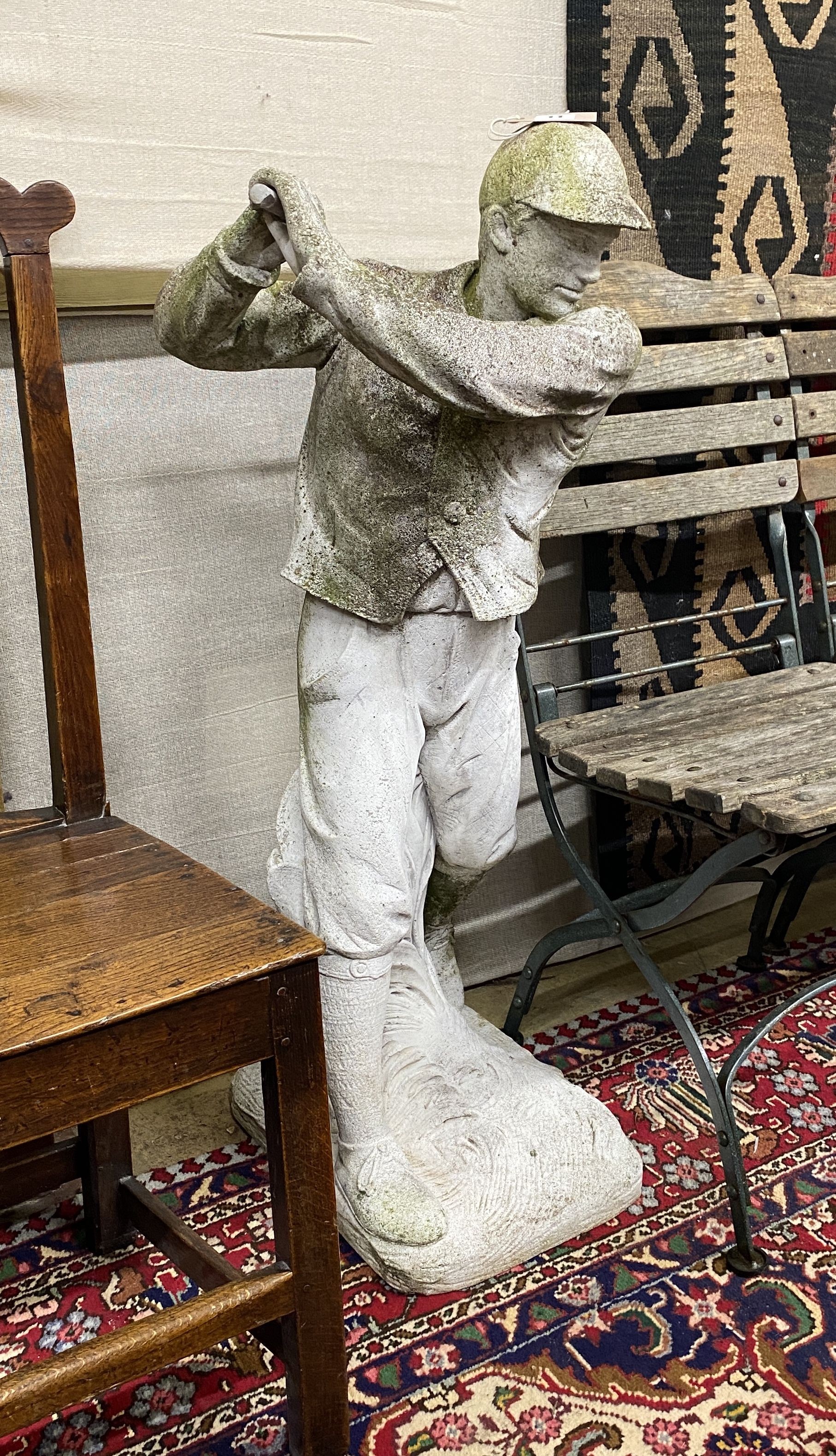 A reconstituted stone garden ornament modelled as a golfer, height 102cm