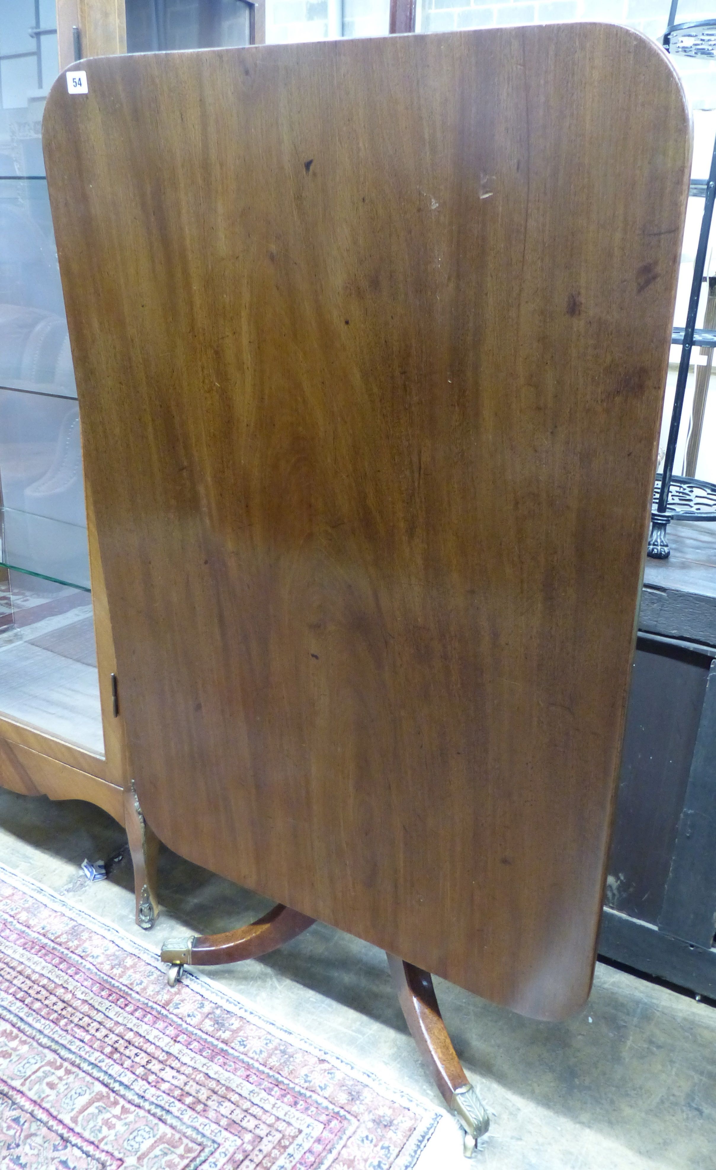A Regency rectangular mahogany tilt top dining table, on downswept tripod base, W.119cm D.82cm H.73cm